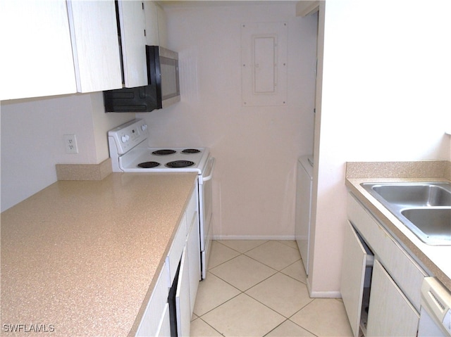 kitchen with white cabinets, electric panel, sink, light tile patterned floors, and white appliances