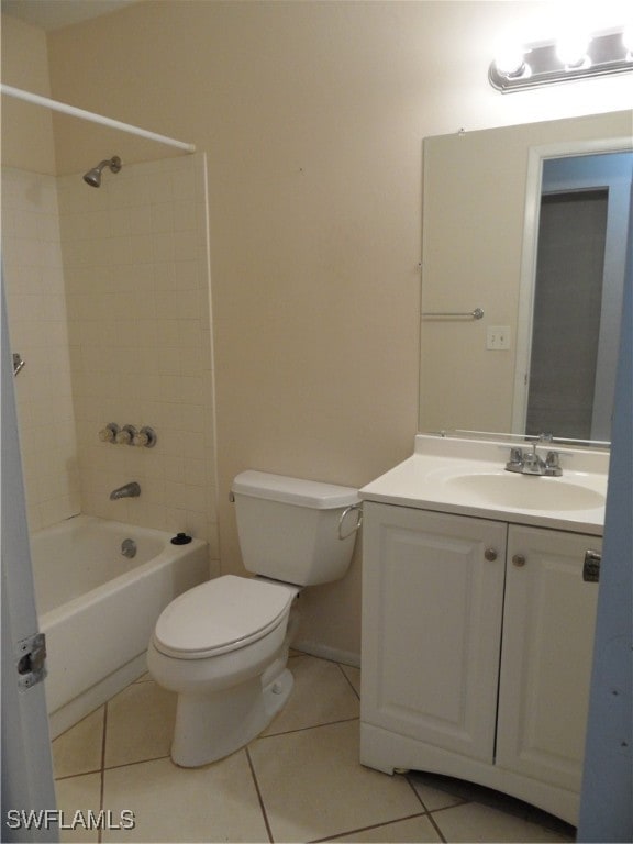 full bathroom with tile patterned flooring, tiled shower / bath combo, vanity, and toilet