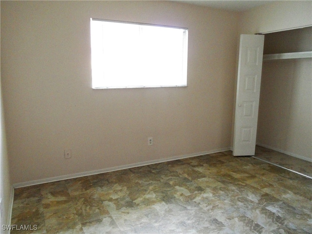 unfurnished bedroom with a closet