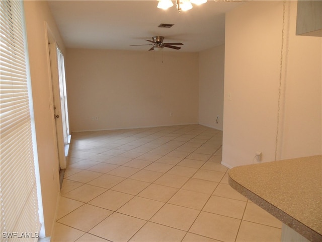 unfurnished room featuring light tile patterned floors and ceiling fan