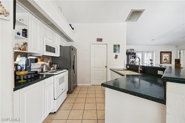 kitchen featuring light tile patterned floors, sink, white appliances, and white cabinets