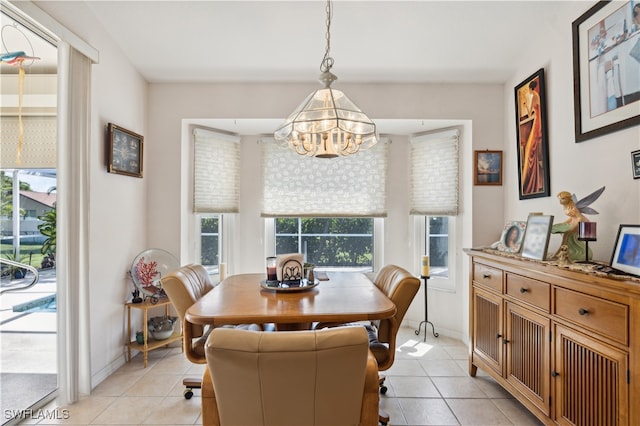 dining space featuring light tile patterned floors and an inviting chandelier