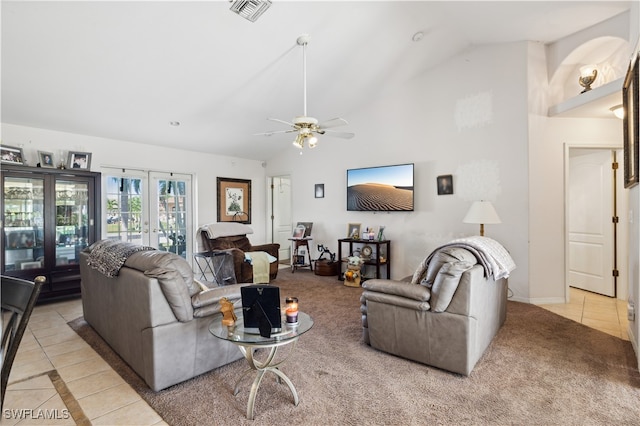 living room with lofted ceiling, light tile patterned floors, ceiling fan, and french doors