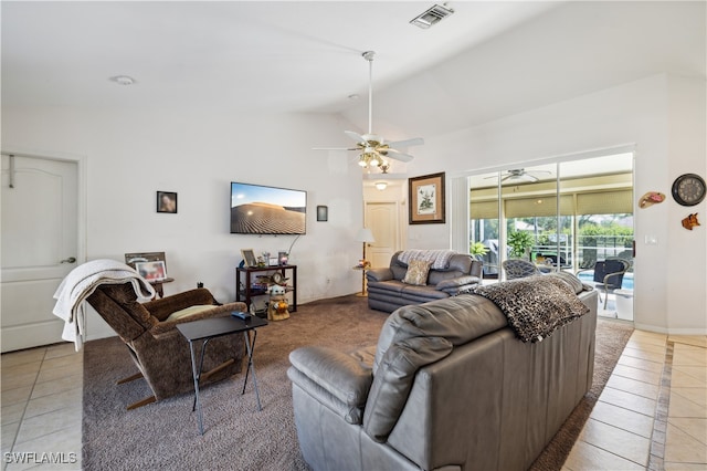 tiled living room with ceiling fan and lofted ceiling