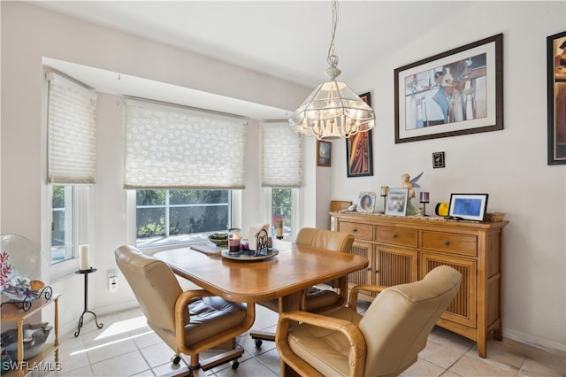 dining room with an inviting chandelier and light tile patterned floors