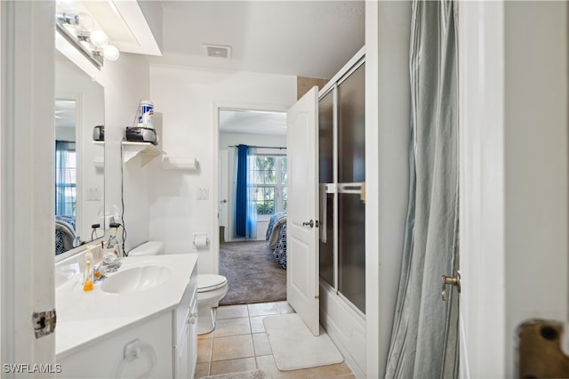 full bathroom with bath / shower combo with glass door, toilet, tile patterned floors, and vanity