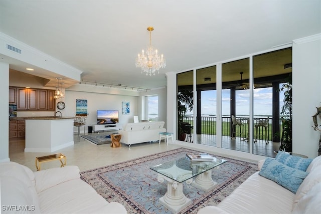 tiled living room with expansive windows, sink, an inviting chandelier, and ornamental molding