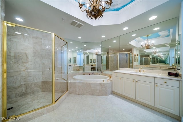 bathroom with separate shower and tub, vanity, a tray ceiling, and a chandelier