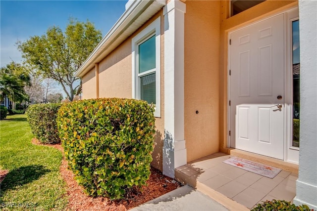 entrance to property with a yard