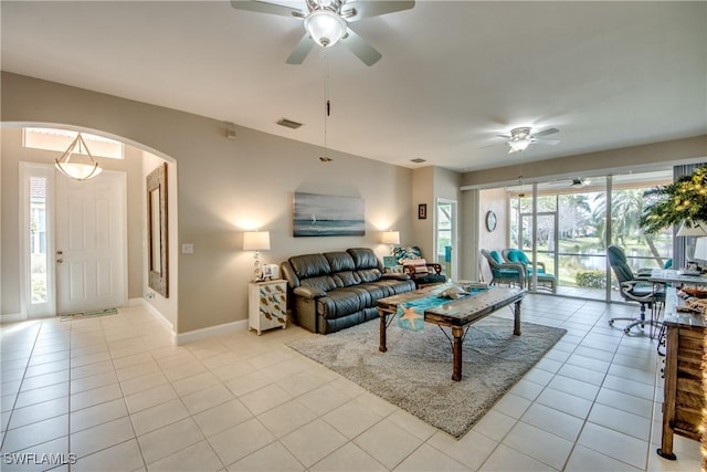 tiled living room featuring ceiling fan