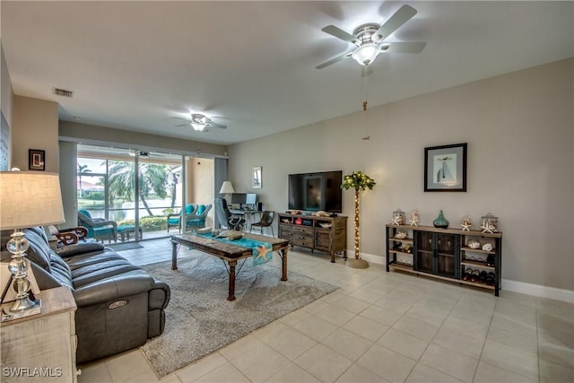 living room featuring light tile patterned floors and ceiling fan