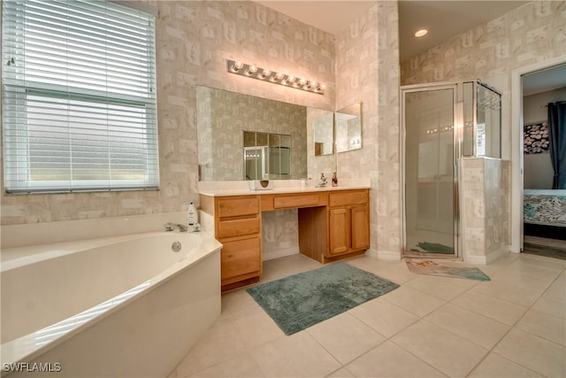 bathroom featuring tile patterned floors, independent shower and bath, and vanity