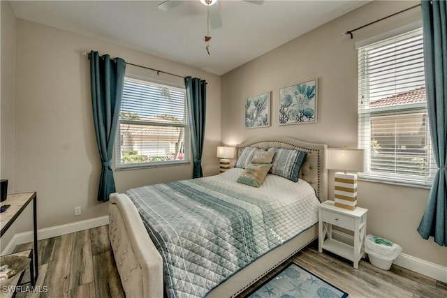 bedroom with hardwood / wood-style floors and ceiling fan