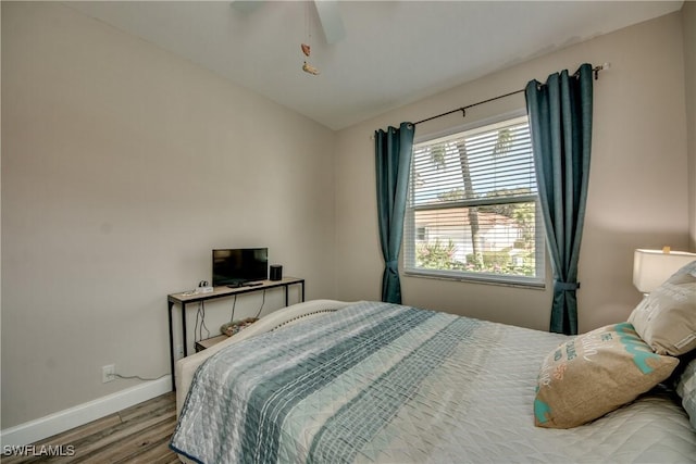 bedroom featuring hardwood / wood-style flooring, ceiling fan, and vaulted ceiling