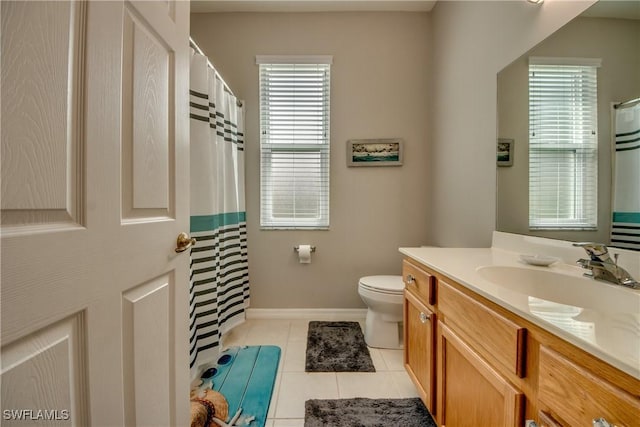 bathroom with vanity, tile patterned floors, and toilet