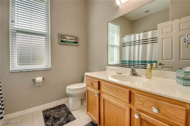 bathroom featuring vanity, tile patterned floors, and toilet