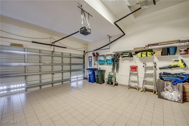 garage with a garage door opener and electric panel