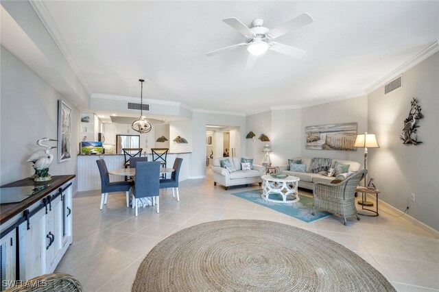 tiled living room with crown molding and ceiling fan