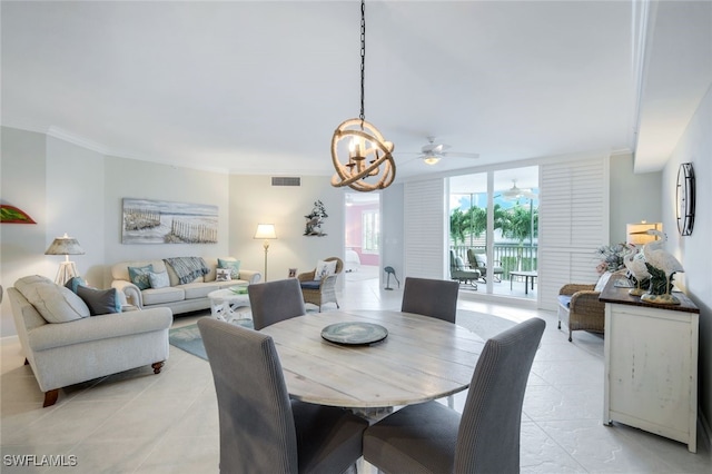 dining area with ceiling fan with notable chandelier and ornamental molding