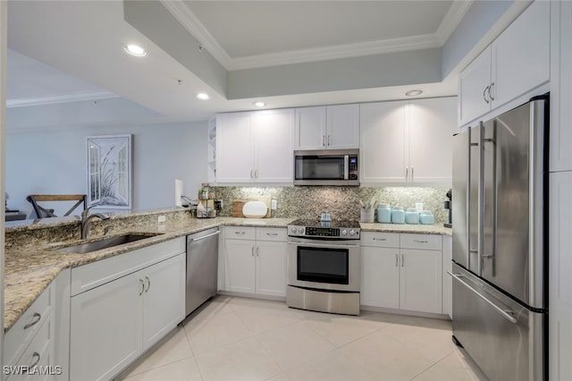 kitchen with sink, white cabinets, stainless steel appliances, backsplash, and crown molding