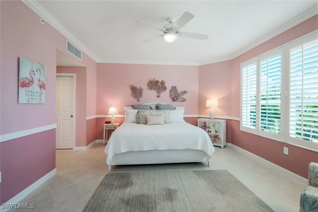 tiled bedroom with ornamental molding and ceiling fan