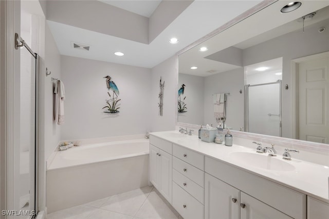 bathroom with independent shower and bath, vanity, and tile patterned floors