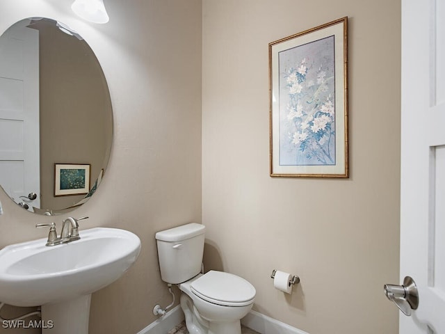 bathroom featuring toilet and sink