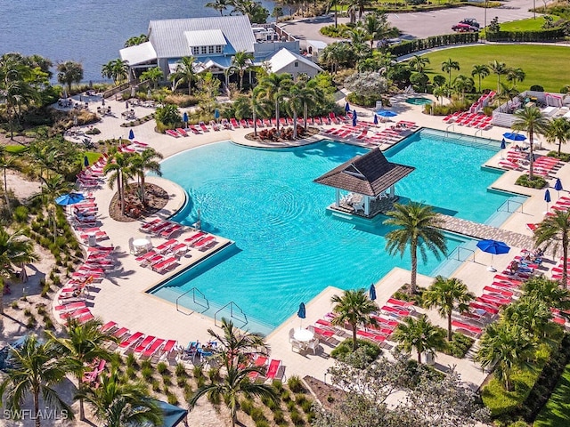 view of swimming pool with a patio and a water view