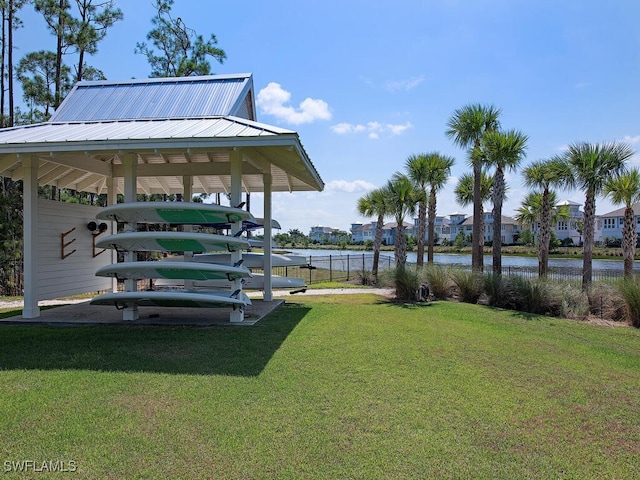 dock area featuring a lawn and a water view