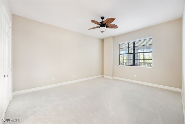 carpeted spare room featuring ceiling fan