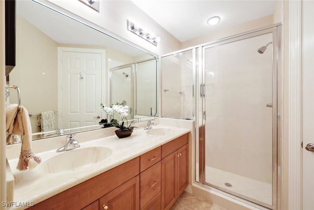 bathroom featuring vanity, tile patterned floors, and a shower with shower door