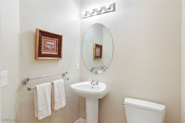 bathroom featuring toilet and sink