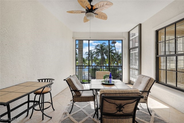 sunroom / solarium with a wealth of natural light and ceiling fan