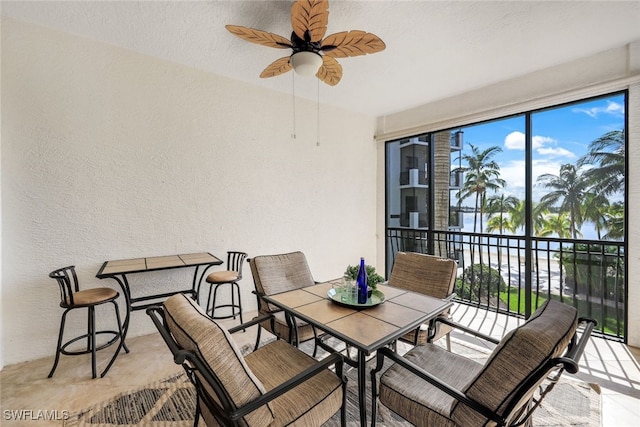 view of patio featuring a balcony and ceiling fan