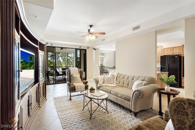 living room featuring light tile patterned flooring and ceiling fan