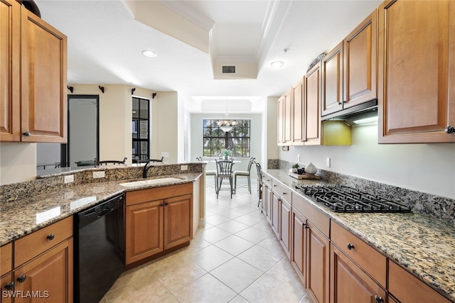 kitchen with dishwasher, sink, gas cooktop, a raised ceiling, and light stone countertops