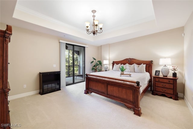 carpeted bedroom with an inviting chandelier, a raised ceiling, and access to outside