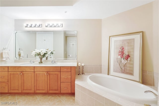 bathroom with vanity, a relaxing tiled tub, and tile patterned floors