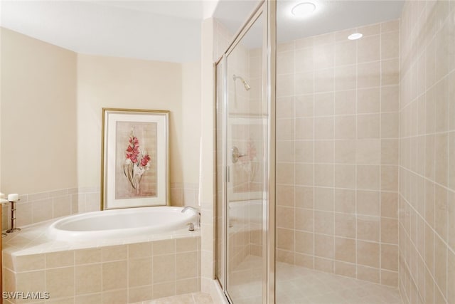 bathroom featuring tile patterned floors and separate shower and tub