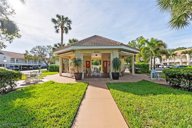 28710 Bermuda Bay Way Unit 104, Bonita Springs, FL 34134 - view of property's community with a lawn and a gazebo