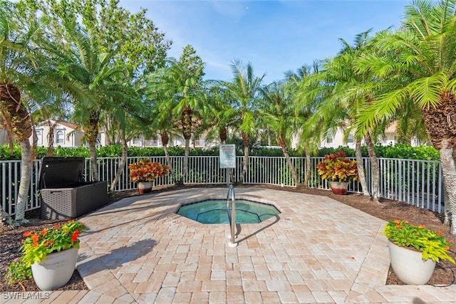 view of swimming pool with a patio and a hot tub