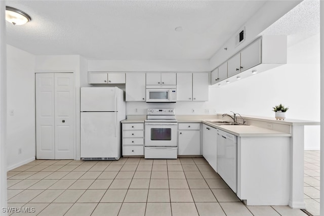 kitchen with a textured ceiling, sink, white cabinets, and white appliances