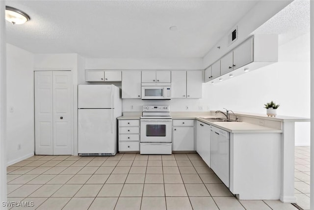 28710 Bermuda Bay Way Unit 104, Bonita Springs, FL 34134 - kitchen with white appliances, a sink, light tile patterned floors, white cabinetry, and a textured ceiling