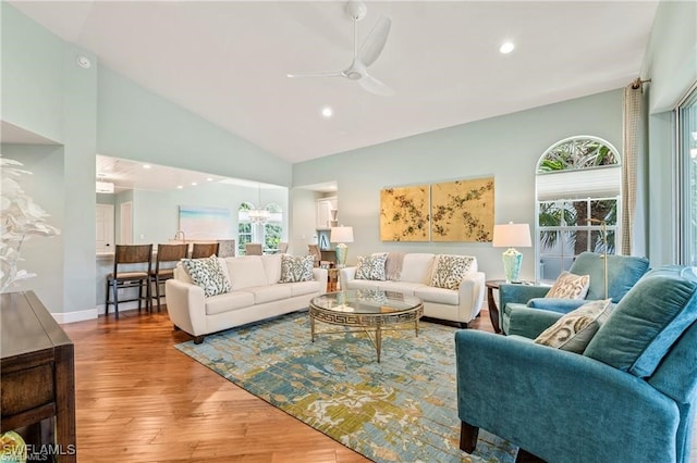 living room with recessed lighting, high vaulted ceiling, ceiling fan, and wood finished floors