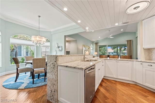 kitchen with a sink, light stone counters, light wood-style floors, white cabinets, and stainless steel dishwasher