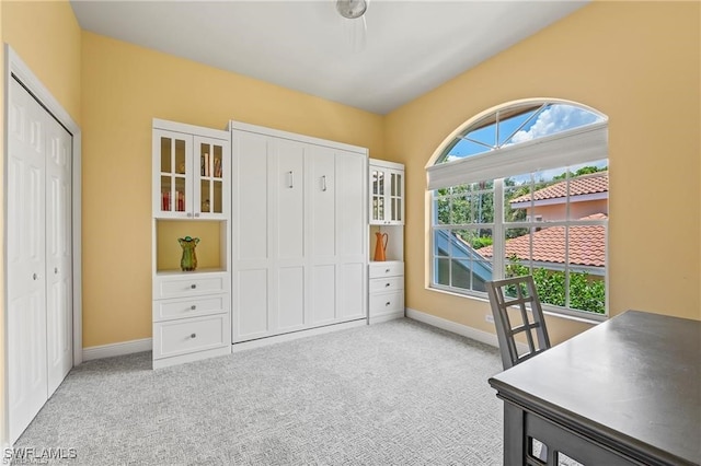 carpeted office featuring baseboards