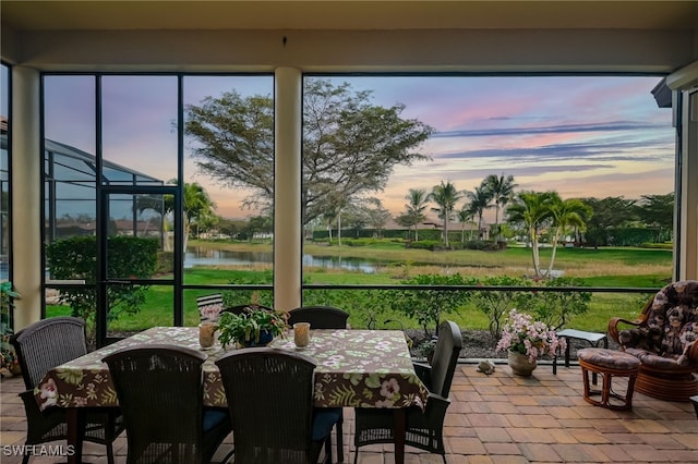 sunroom / solarium with a water view