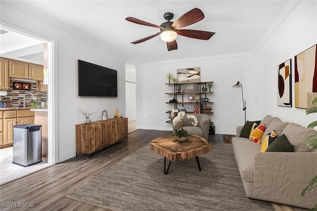 living room featuring crown molding, dark hardwood / wood-style floors, and ceiling fan