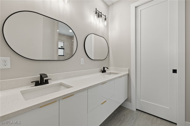 bathroom with vanity and hardwood / wood-style flooring