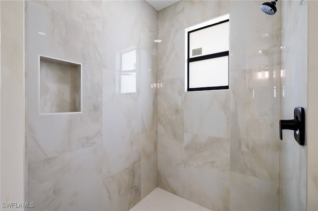 bathroom with a tile shower